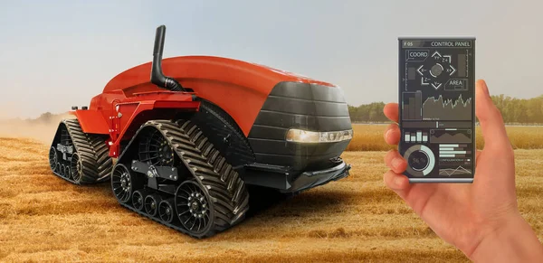 Farmer controls an autonomous tractor