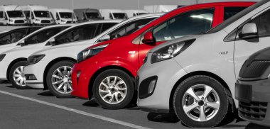Black and white image of a row of cars. Only the red car has color clipart