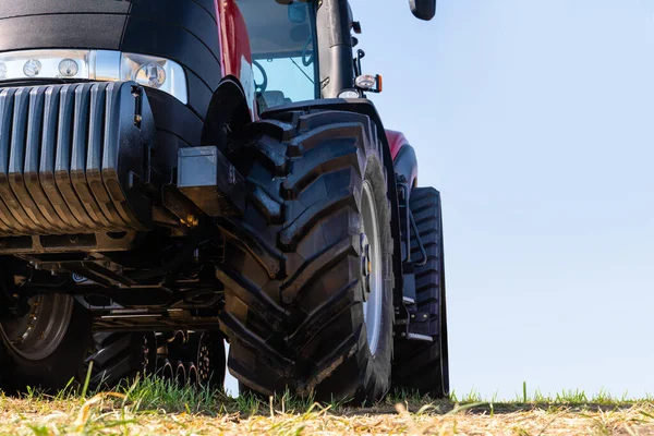 Röd traktor på ett fält — Stockfoto