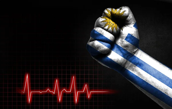 Flag of Uruguay painted on male fist, the concept image shows the strength of medicine or politics in countries, photography has a good place for your text