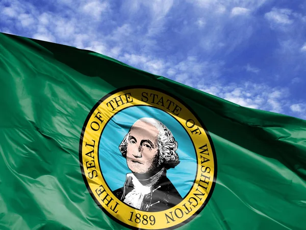 waving flag State of Washington close up against blue sky