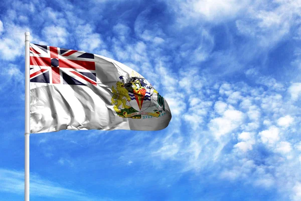 National flag of British Antarctic Territory on a flagpole in front of blue sky