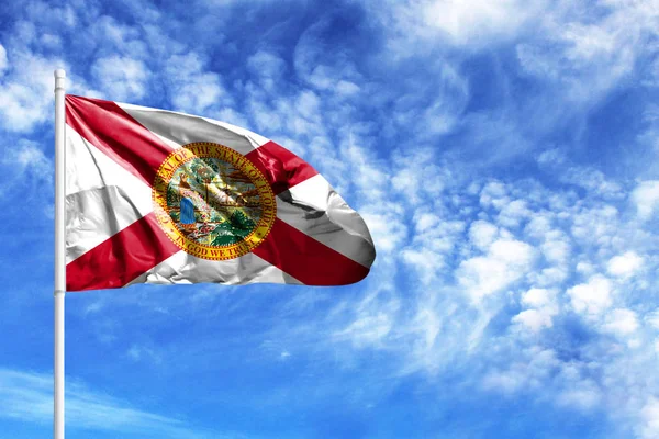 National flag State of Florida on a flagpole in front of blue sky