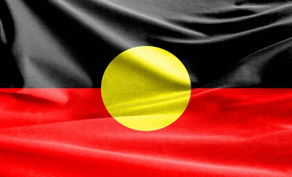 Realistic flag of Australian Aboriginal on the wavy surface of fabric