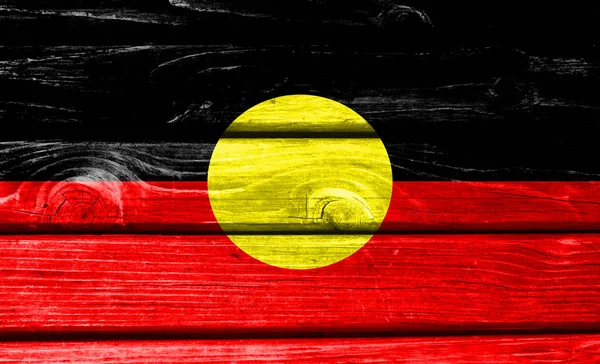 Australian Aboriginal flag painted on wooden background, closeup.