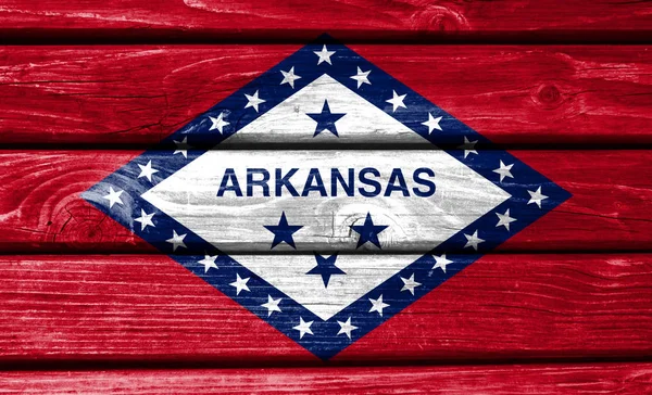 State of Arkansas flag painted on wooden background, closeup.