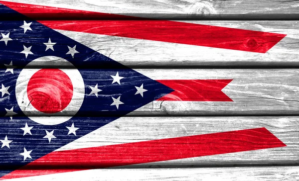 State of Ohio flag painted on wooden background, closeup.