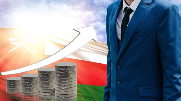 Business concept of increasing sales, Businessman on the background of the flag of Oman and a graph of increasing up.