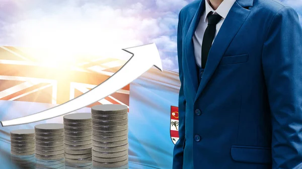 Business concept of increasing sales, Businessman on the background of the flag of Fiji and a graph of increasing up.