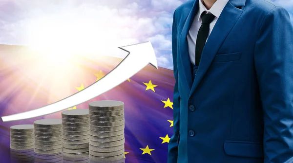 Business concept of increasing sales, Businessman on the background of the flag of European Union and a graph of increasing up.