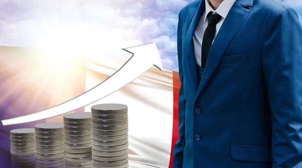 Business concept of increasing sales, Businessman on the background of the flag of France and a graph of increasing up.