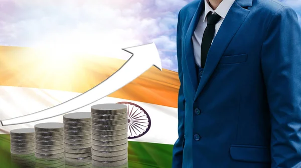 Business concept of increasing sales, Businessman on the background of the flag of India and a graph of increasing up.