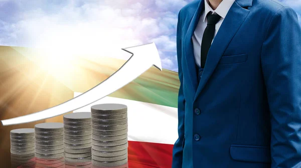 Business concept of increasing sales, Businessman on the background of the flag of Kuwait and a graph of increasing up.