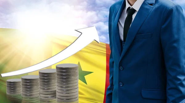 Business concept of increasing sales, Businessman on the background of the flag of Senegal and a graph of increasing up.
