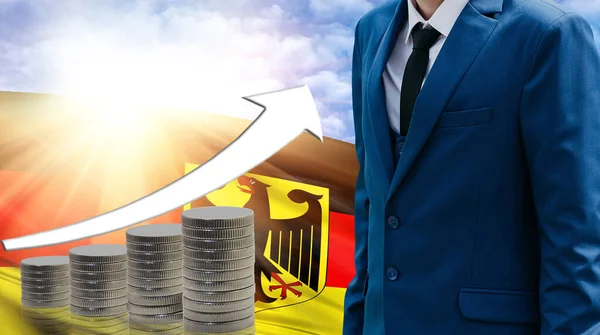 Business concept of increasing sales, Businessman on the background of the flag of Germany and a graph of increasing up.