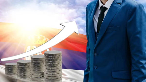 Business concept of increasing sales, Businessman on the background of the flag of Serbia and a graph of increasing up.