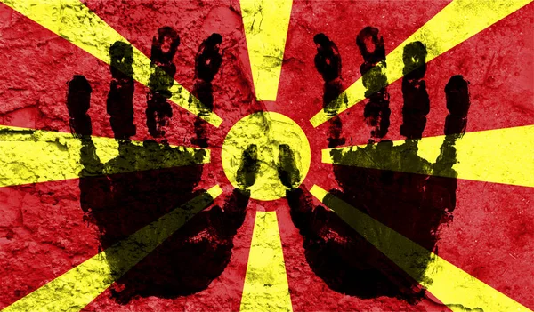 Handprints on the background of the flag of Macedonia. Freedom of choice, corruption, and detention concept