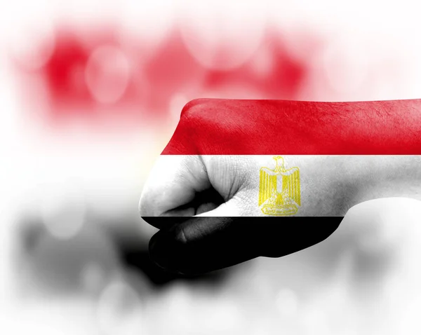 Flag of Egypt painted on male fist, strength,power,concept of conflict. On a blurred background.