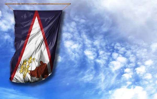 Flag of American Samoa. Vertical flag, against blue sky with place for your text