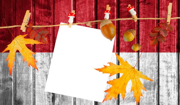 Indonesia flag on autumn wooden background with leaves and good place for your text.