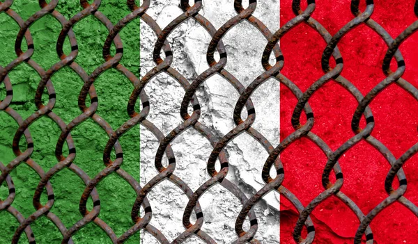 Immigration policy regarding migrants, illegal immigrants and refugees. Steel grid on the background of the flag of Italy