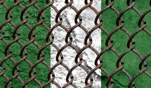 Immigration policy regarding migrants, illegal immigrants and refugees. Steel grid on the background of the flag of Nigeria