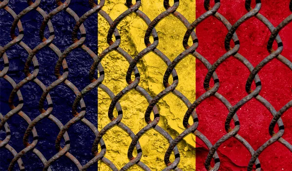 Immigration policy regarding migrants, illegal immigrants and refugees. Steel grid on the background of the flag of Chad