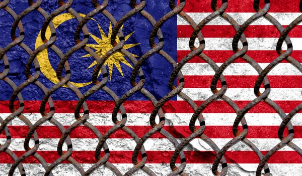Immigration policy regarding migrants, illegal immigrants and refugees. Steel grid on the background of the flag of Malasia