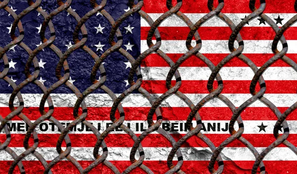 Immigration policy regarding migrants, illegal immigrants and refugees. Steel grid on the background of the flag of Bikini Atoll