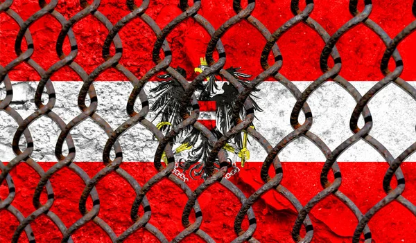 Immigration policy regarding migrants, illegal immigrants and refugees. Steel grid on the background of the flag of Austria