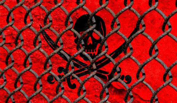Immigration policy regarding migrants, illegal immigrants and refugees. Steel grid on the background of the flag of Pirates red
