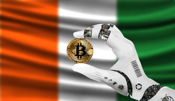 crypto currency bitcoin in the robot\'s hand, the concept of artificial intelligence, background flag of Cote d,lvoire