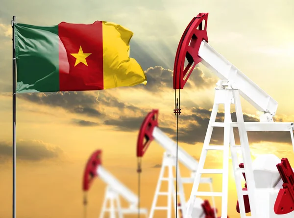 Oil rigs against the backdrop of the colorful sky and a flagpole with the flag of Cameroon. The concept of oil production, minerals, development of new deposits.