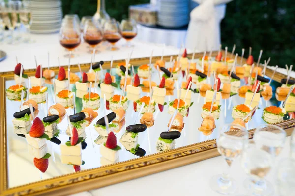 Delicious snacks on wedding reception table in luxury outdoor restaurant — Stock Photo, Image
