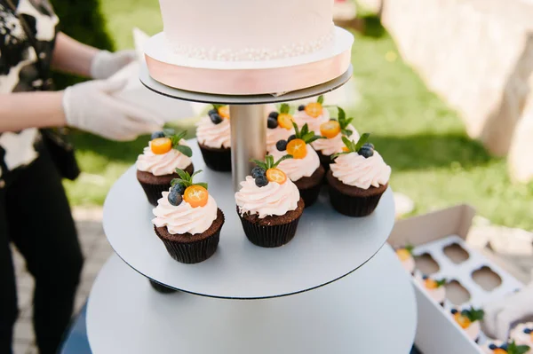 Sweet wedding cake made from fresh berry cupcake with bokeh background