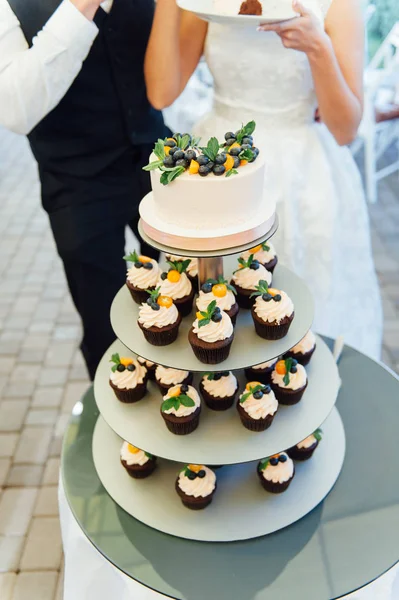 Sweet wedding cake made from fresh berry cupcake with bokeh background