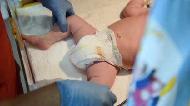 Neonatal återupplivning. Kvinnliga läkare undersöka nyfödd baby i klinik — Stockvideo