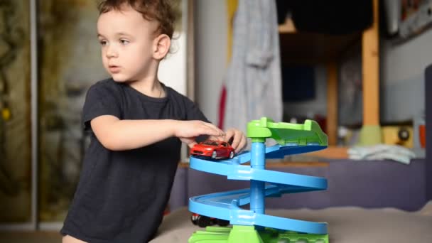 Little boy playing with toy car in the childrens room — Stock Video