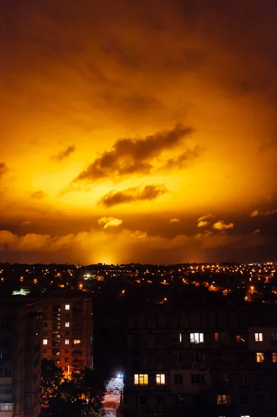 red sky lighting at night. Light comes from a greenhouse with large lamps