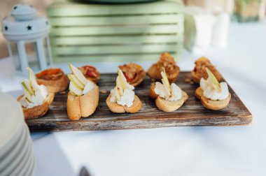 Lüks bir açık hava restoranında düğün masasında lezzetli atıştırmalıklar.