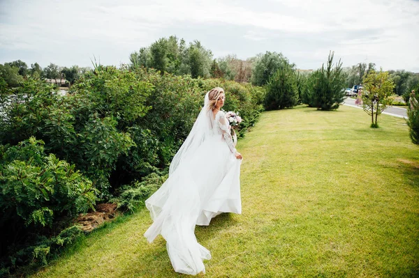 Beautiful bride in fashion wedding dress on natural background. A beautiful bride in the forest. — Stock Photo, Image