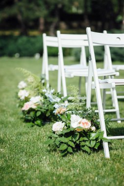 Giden düğün töreni. Dekor Stüdyosu. yeşil bir çim üzerinde beyaz ahşap sandalyeler.
