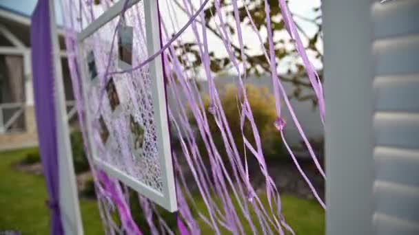 Wedding ceremony decoration on wind. Wind blows colorful ribbons in spring sunlight — Stock Video