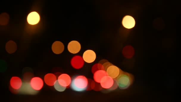 Beautiful glittering bokeh in dark blurry background at night. — Stock Video