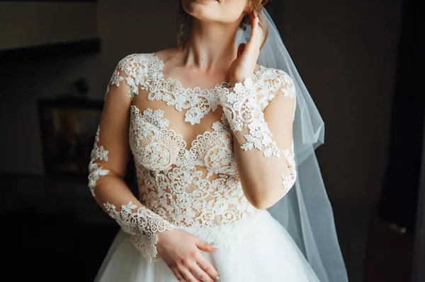 Gorgeous charming sexy bride in white lace dress in hotel room near the door of balcony — Stock Photo, Image
