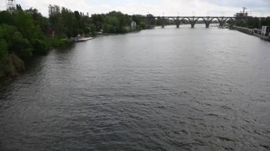 River, flows in the city of Dnieper, Ukraine. A railway arch bridge is visible in the background.