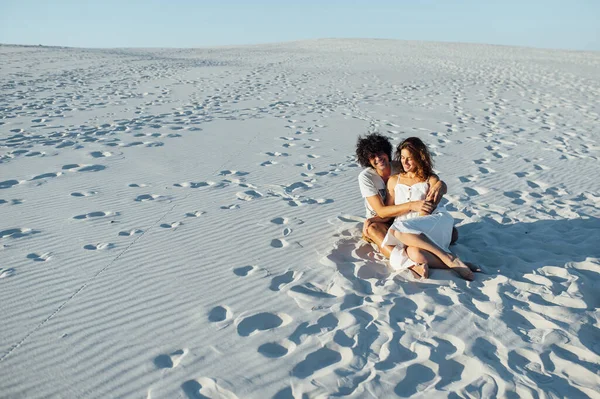 Um cara de cabelos encaracolados e uma linda garota estão se divertindo na praia — Fotografia de Stock