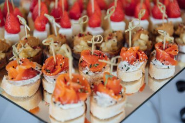 Sandviç, kanepe ve kekler festival masasında. Çok çeşitli atıştırmalıklar.