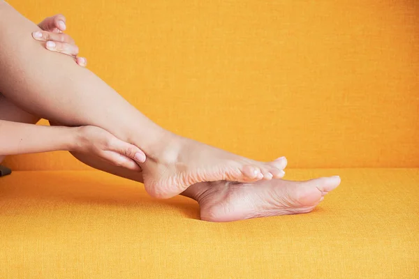 Young asian girl suffering from pain in leg at home — Stock Image Young asian girl suffering from pain in leg at home Royalty Free Stock Images