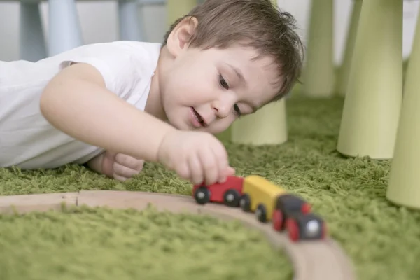 Μικρό παιδί στην αίθουσα πολύχρωμο παιδιά σε ένα νηπιαγωγείο ή την προσχολική ηλικία. παιδί αγόρι παίζει με δείκτες παιχνίδια στο σπίτι. Ασίας μωρό 2 ετών παίζει μόνος σε ένα καταπράσινο χαλί. — Φωτογραφία Αρχείου